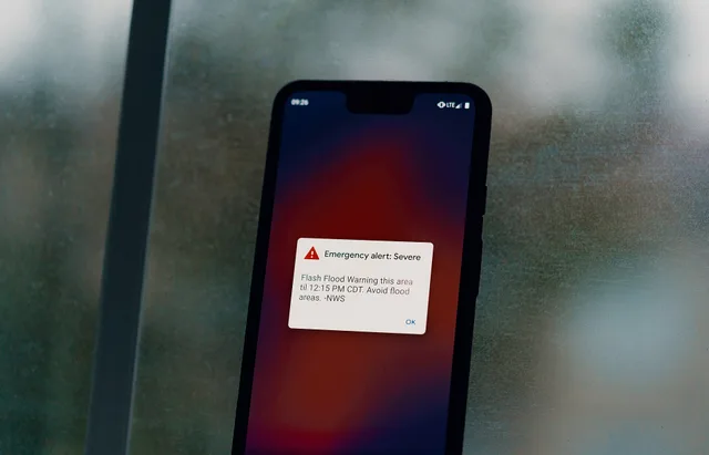 An emergency weather alert from the National Weather Service warns of a flash flood warning on an Android Pixel 3 XL smartphone, during a thunderstorm in Austin, Texas: "Emergency alert: Severe - Flash Flood Warning this area til 12:15 PM CDT. Avoid flood areas. -NWS". Breaking news evidence channels compared