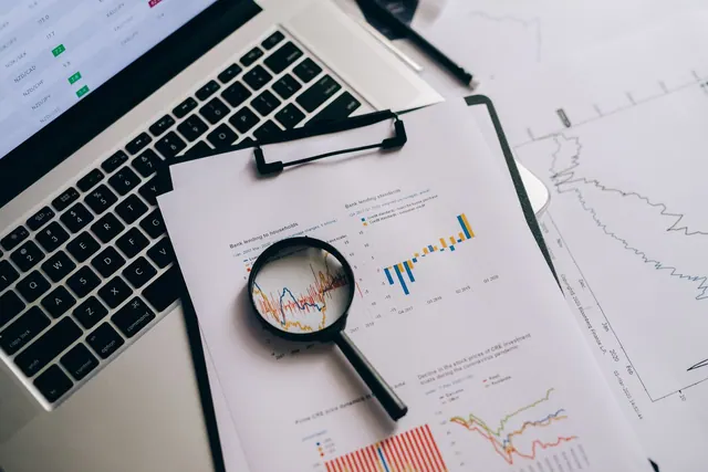 Overhead view of financial charts, laptop, and magnifying glass, ideal for business analysis themes. Common statistics and chart reporting problems