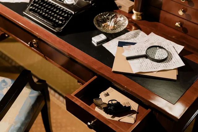 A moody vintage detective's desk with typewriter, magnifying glass, and secret documents. Fictional case: correcting a circular citation that became a fact