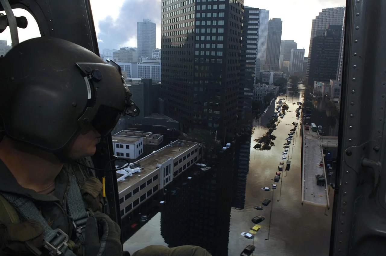 new orleans, louisiana, hurricane katrina, flooded, flooding, floods, helicopter, crewman, streets, buildings, downtown, city, cities, nature, architecture, sky, clouds, devastation, damage, blue news, blue street, blue new. Fictional case: correcting an old flood video labeled as current