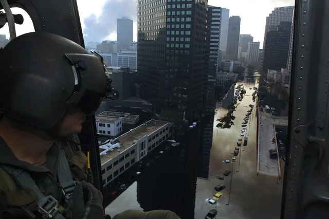 new orleans, louisiana, hurricane katrina, flooded, flooding, floods, helicopter, crewman, streets, buildings, downtown, city, cities, nature, architecture, sky, clouds, devastation, damage, blue news, blue street, blue new. Fictional case: correcting an old flood video labeled as current