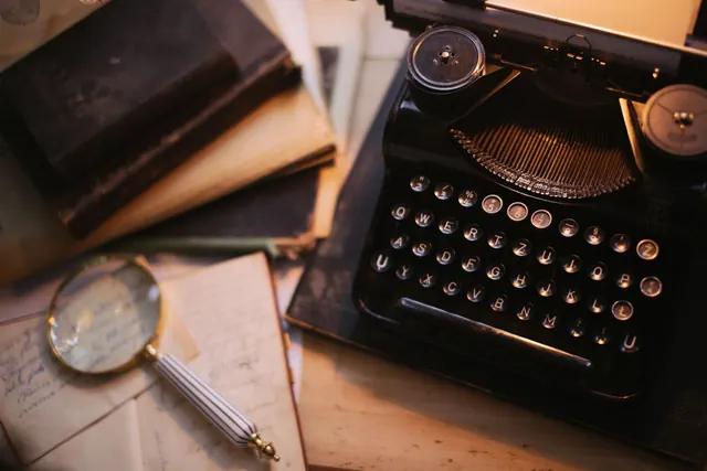 A vintage typewriter with a magnifying glass and old books on a desk, evoking nostalgia. Public document types and statuses compared