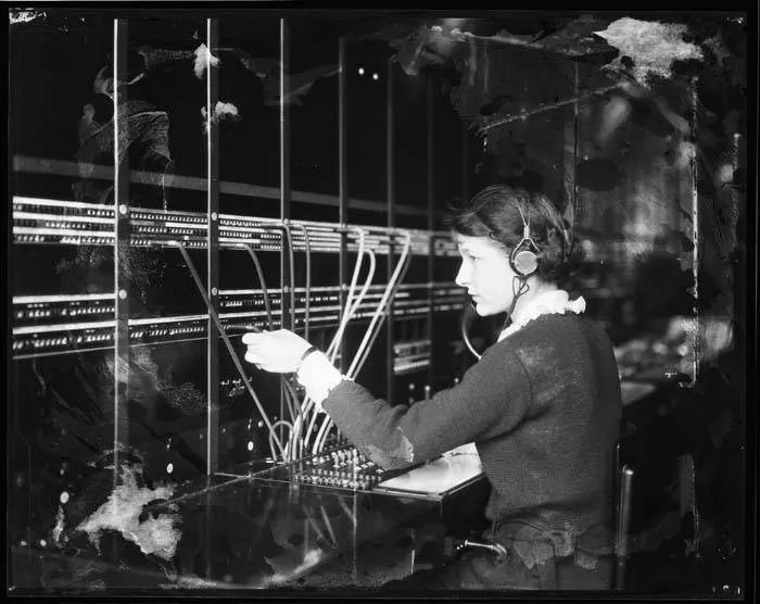 A Seattle telephone switchboard operator connecting calls around 1922